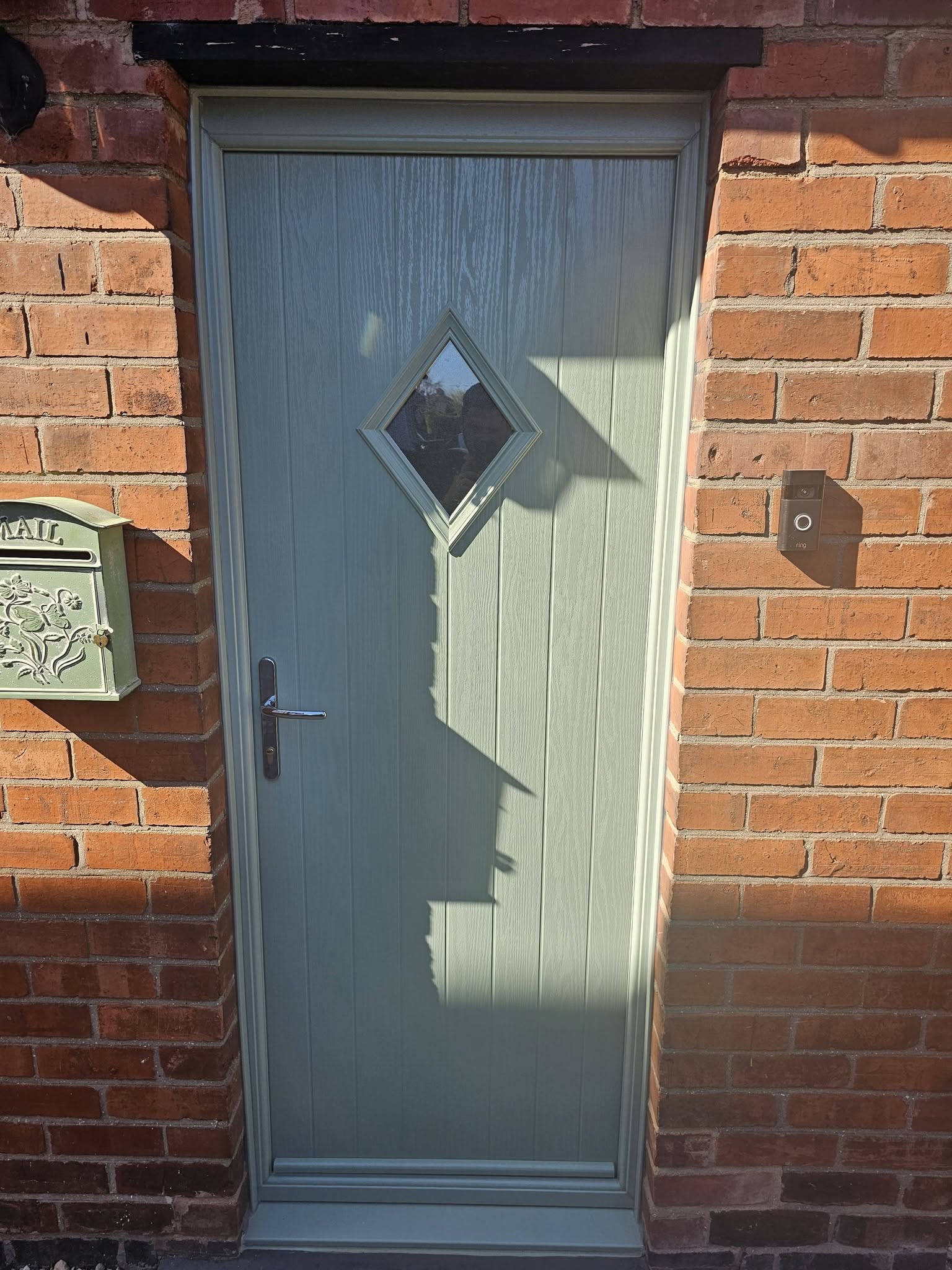Green door with diamond glass